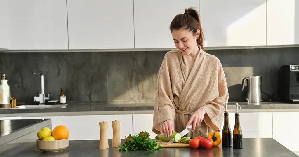 Fenntartható étkezés a mindennapokban: friss zöldségek előkészítése otthoni konyhában, nyugodt és tudatos életmódot tükröző környezetben.